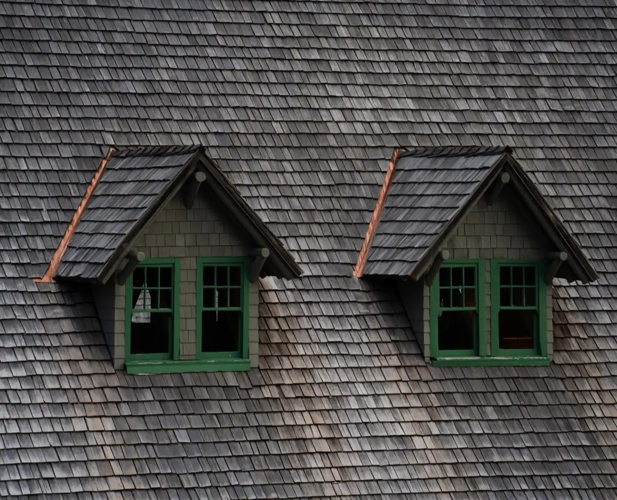 Dormers on a shingle roof in Midland, TX, where step flashing and kickout flashing carry water past the walls